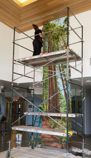 Local artist paints the dramatic two-story mural.