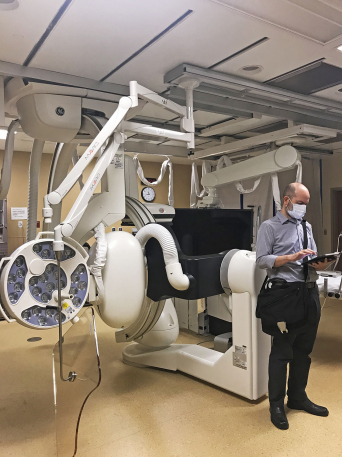 man working with ipad in operating room