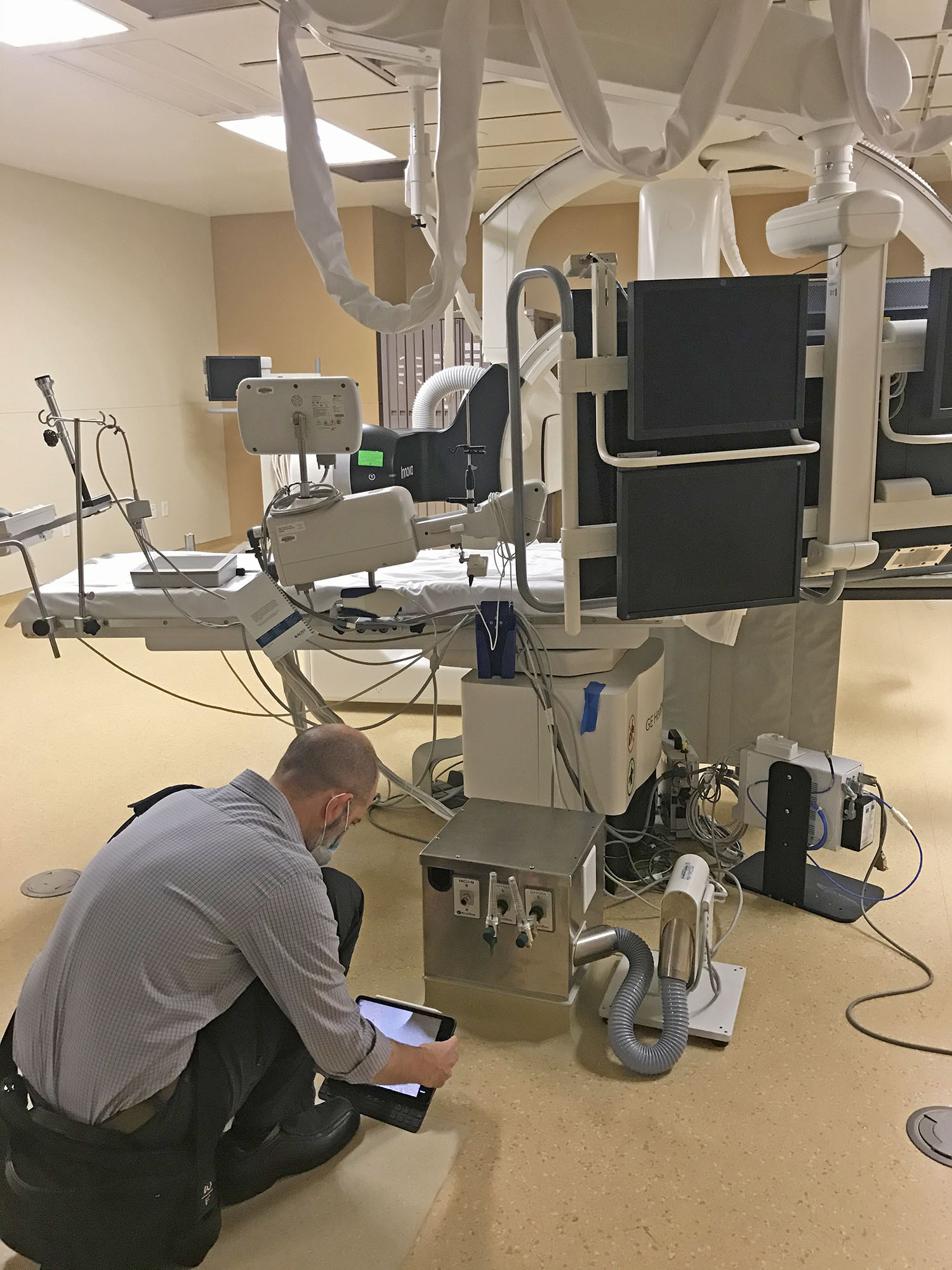 man working with ipad in operating room