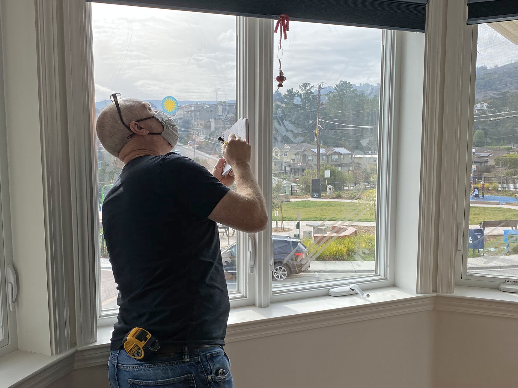 man sealing window